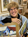 Photo of Anne Hanna painting in her studio